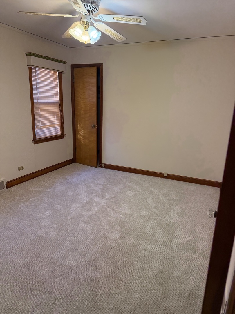 10210 South Rhodes Avenue Chicago, IL 60628 - Photo 5 of 12 an empty room with a window