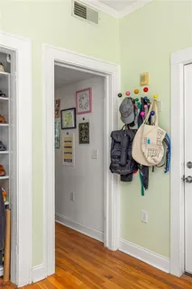 a view of a hallway with entryway wooden floor and front door