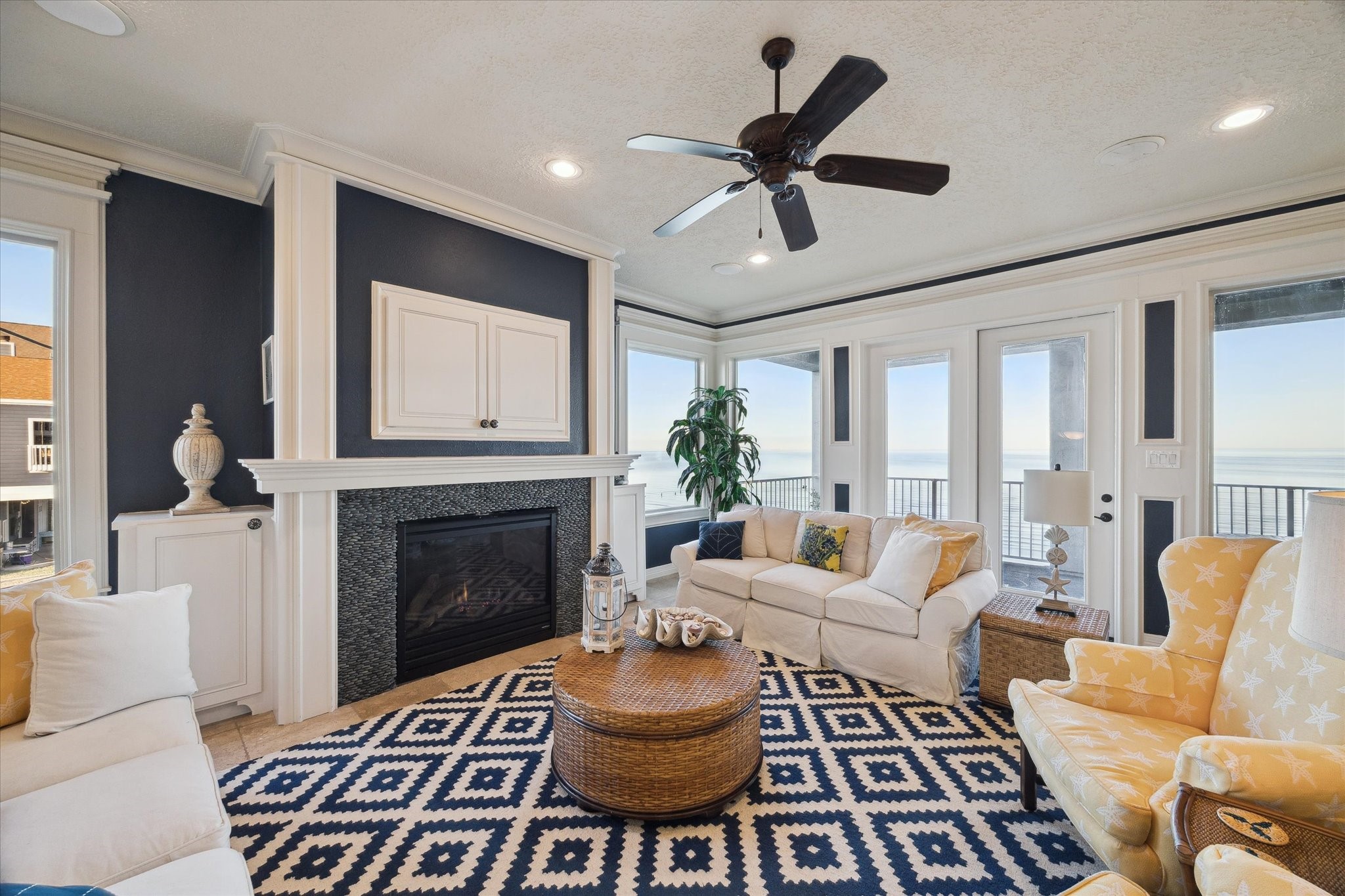 1406 Todville Road Seabrook, TX 77586 - Photo 16 of 50 BEAUTIFULLY FINISHED DEN FEATURES EXTENSIVE MOLDINGS, A FIREPLACE WITH A GLASS STONE SURROUND, AV STORAGE AND BUILT-IN SPEAKERS.