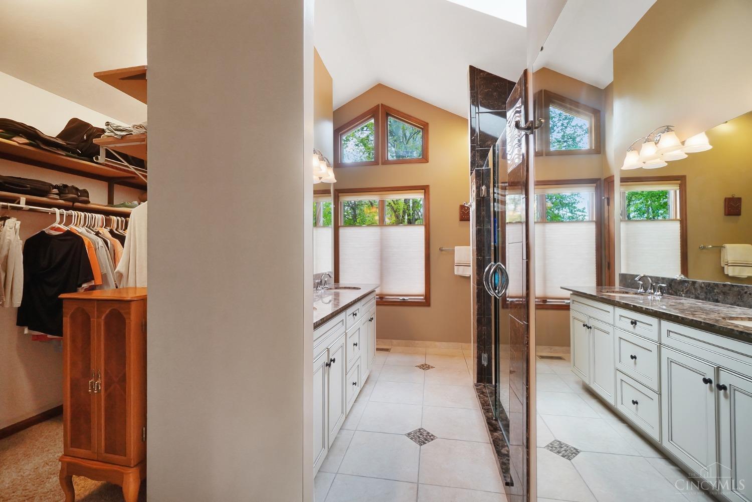 10907 Sand Run Road Harrison, OH 45030 - Photo 42 of 88 The remodeled primary bath has a 14 ft walk-in closet, double headed/tiled shower with bench, linen closet, skylight, double vanity and heated flooring!