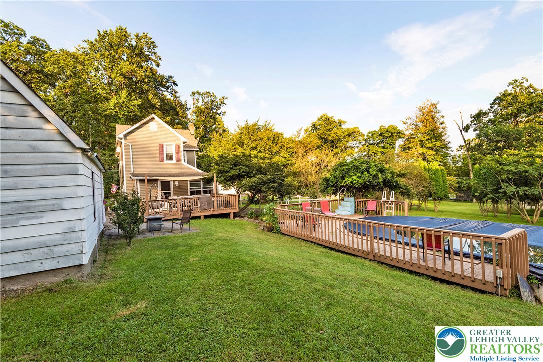 1114 Fox Gap Road Bangor, PA 18013 - Photo 56 of 63 An expansive green lawn connects the main house deck to a fenced backyard pool area.