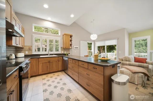 a kitchen with stainless steel appliances granite countertop a sink and cabinets