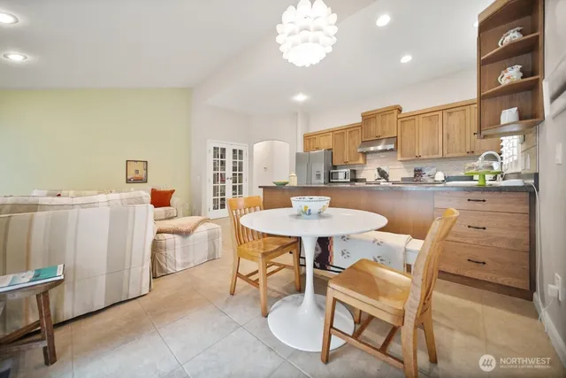 a dining room with furniture and a chandelier