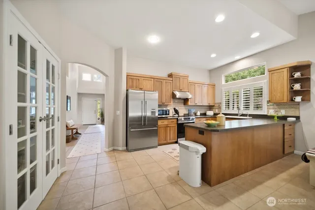 a kitchen with a refrigerator and microwave