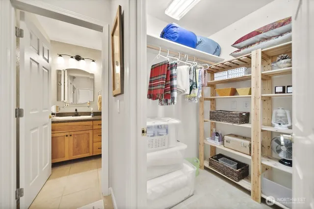 a bathroom with a refrigerator and a sink