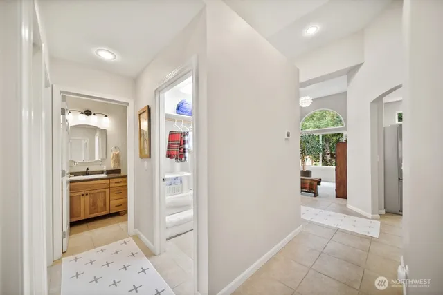 a spacious bedroom with a bed and glass window