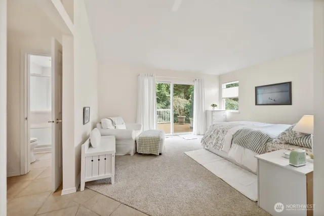 a bedroom with a large bed and a large window