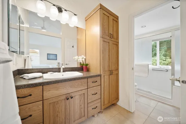 a bathroom with a glass shower door