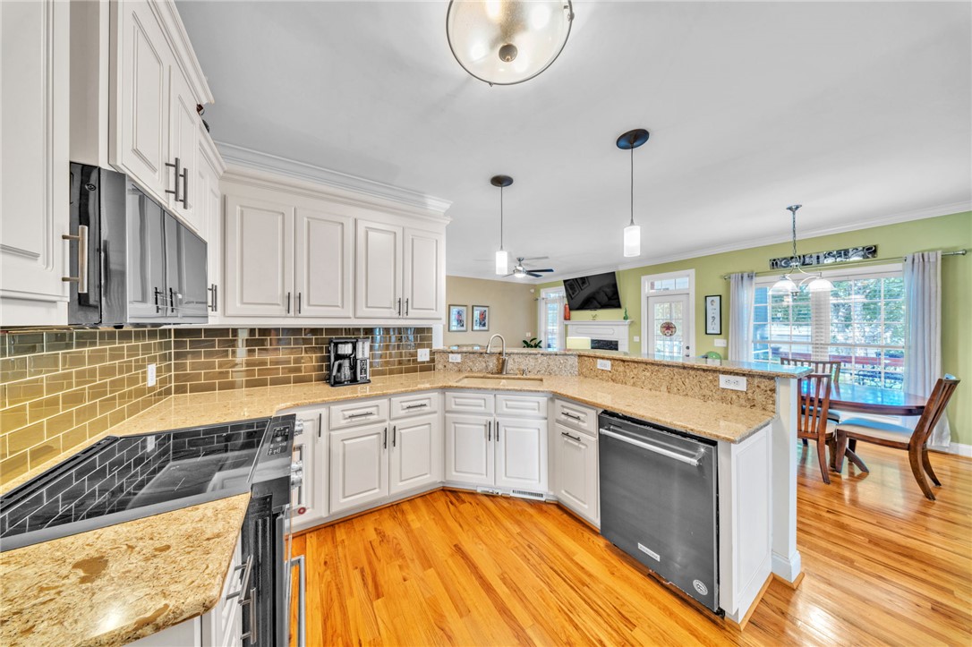 648 Mountain View Road Williamston, SC 29697 - Photo 12 of 42 Granite counters and hardwood floors elevate this luminous culinary space.