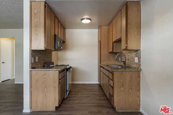 a kitchen with stainless steel appliances granite countertop a stove and a sink
