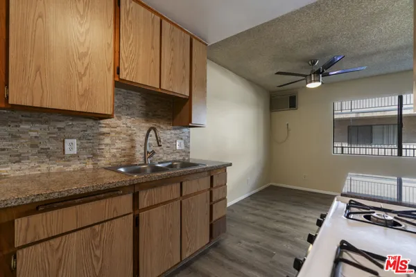 a kitchen with sink cabinets and window