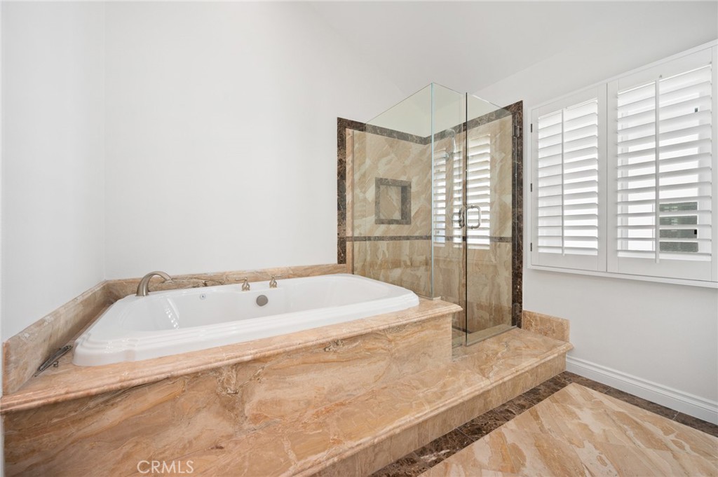 16 Charmony Laguna Niguel, CA 92677 - Photo 12 of 37 a spacious bathroom with a bathtub and next to a window