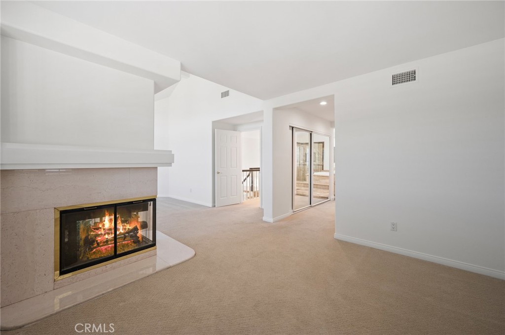 16 Charmony Laguna Niguel, CA 92677 - Photo 14 of 37 a view of an empty room with a fireplace