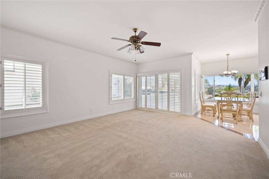 16 Charmony Laguna Niguel, CA 92677 - Photo 25 of 37 a big room with windows and chandelier fan