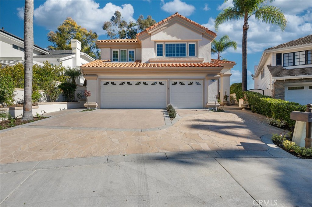 16 Charmony Laguna Niguel, CA 92677 - Photo 31 of 37 a front view of a house with a yard and garage