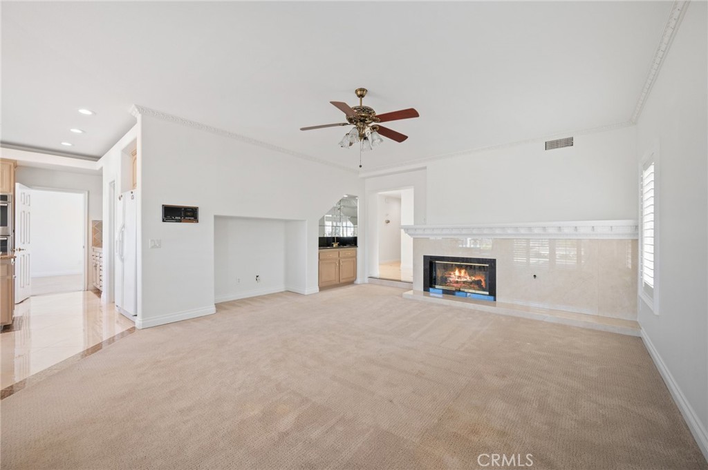 16 Charmony Laguna Niguel, CA 92677 - Photo 7 of 37 a view of a livingroom with a fireplace and a chandelier fan
