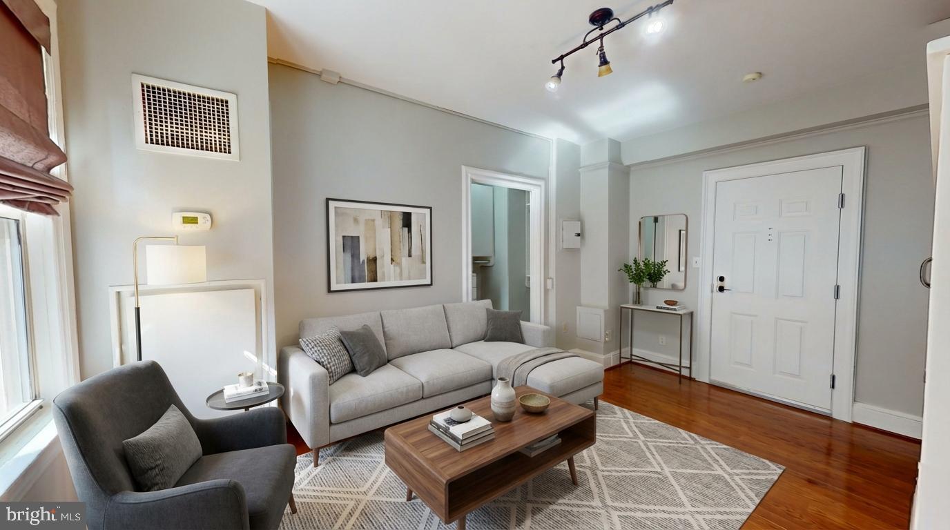 3446 Connecticut Avenue Northwest, Unit 203 Washington, DC 20008 - Photo 4 of 11 a living room with furniture and wooden floor