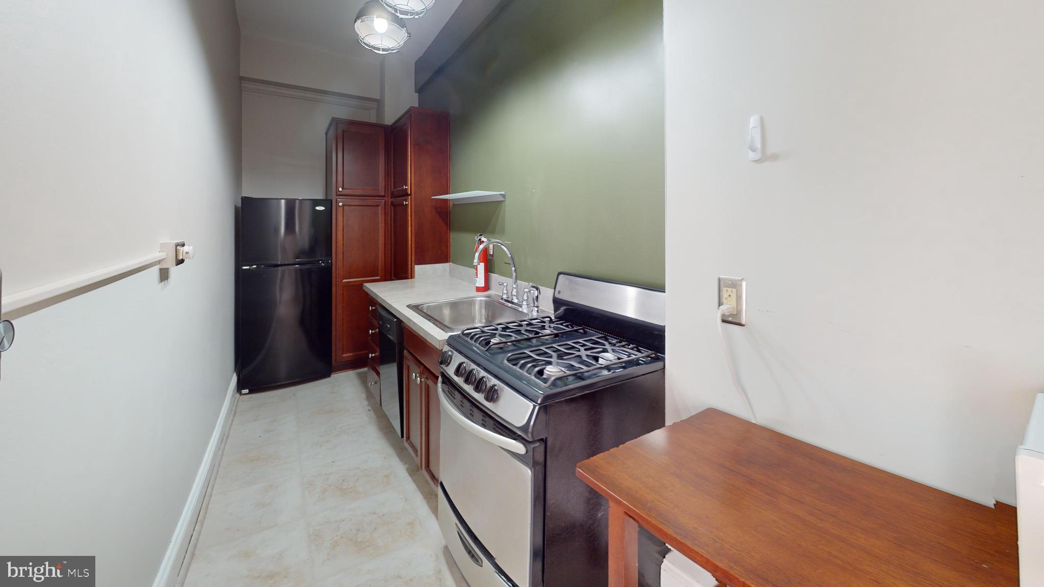 3446 Connecticut Avenue Northwest, Unit 203 Washington, DC 20008 - Photo 10 of 11 a kitchen with a stove and a refrigerator
