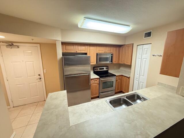6768 Heritage Grande, Unit 7206 Boynton Beach, FL 33437 - Photo 2 of 9 a kitchen with a refrigerator sink and cabinets