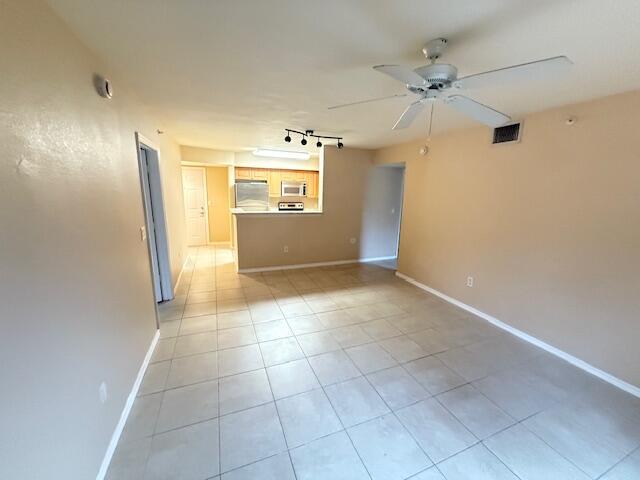 6768 Heritage Grande, Unit 7206 Boynton Beach, FL 33437 - Photo 3 of 9 a view of a hallway with a chandelier