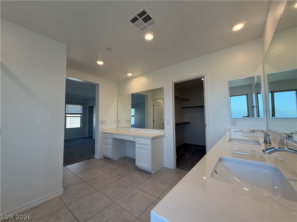 3228 Azalea Ridge Court Henderson, NV 89052 - Photo 11 of 28 A well-appointed primary bathroom featuring a spacious vanity with dual sinks and ample counter space.