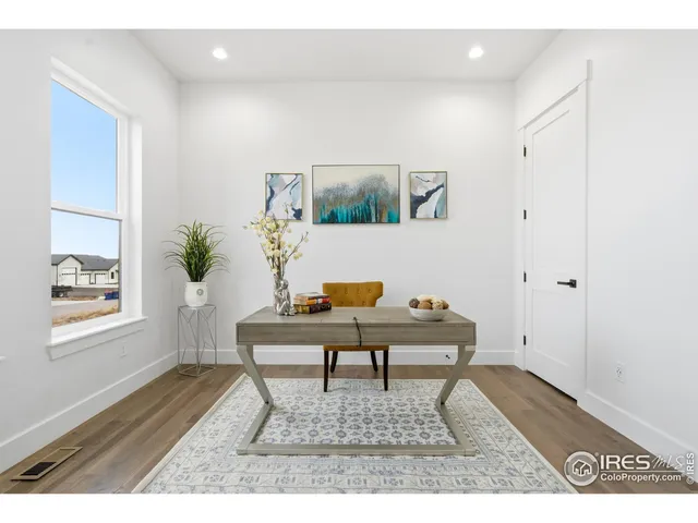 a view of a dining room with furniture window and wooden floor