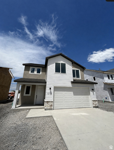 1213 West 500 South Logan, UT 84321 - Photo 1 of 32 Contemporary two-story residence featuring a two-car garage, white siding, stone accent detailing, and a covered entry