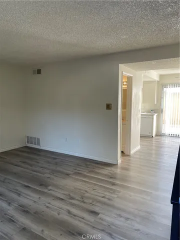 a view of an empty room and wooden floor