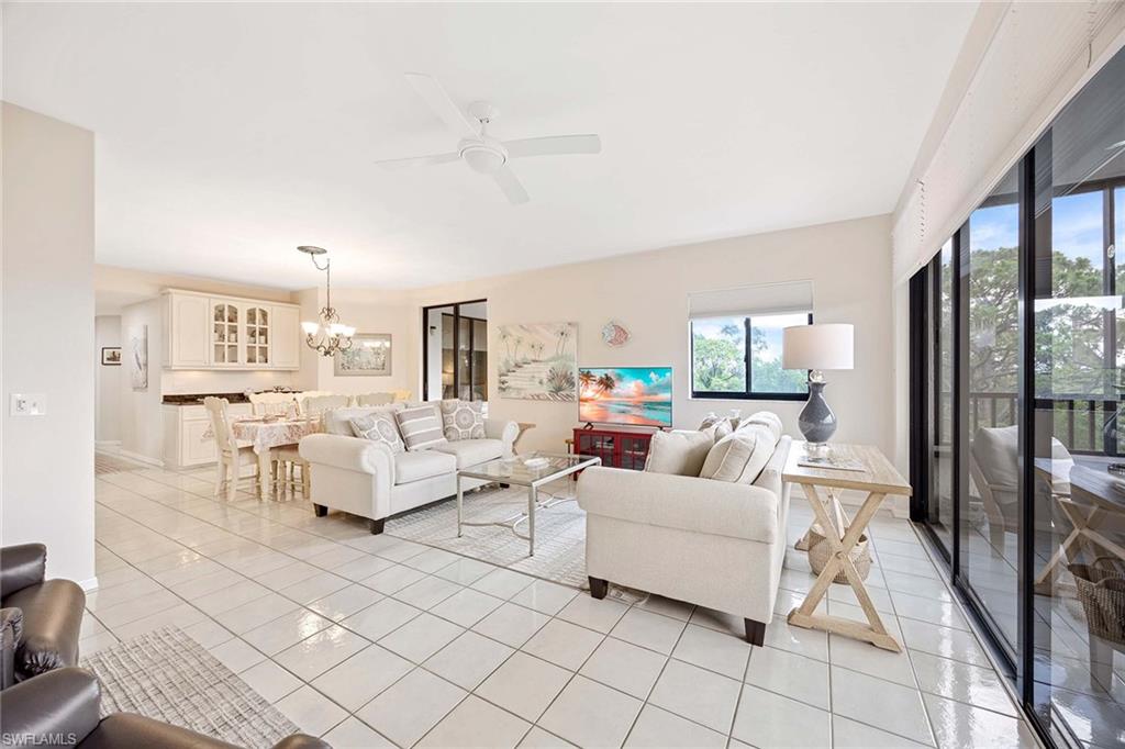 6500 Valen Way, Unit A402 Naples, FL 34108 - Photo 11 of 49 a living room with furniture and a table