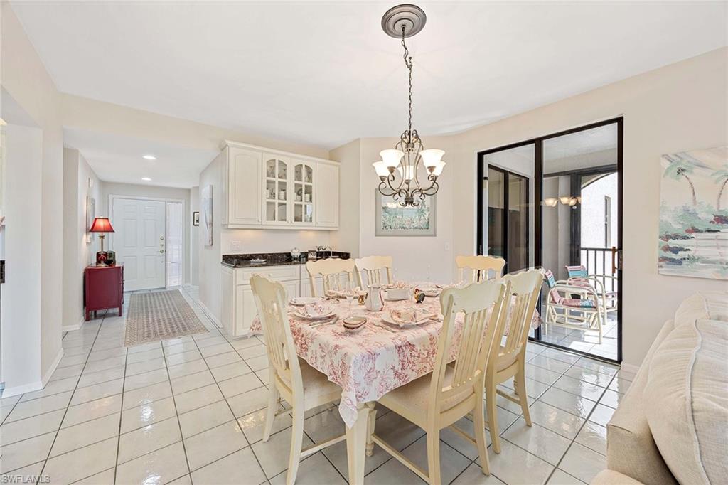 6500 Valen Way, Unit A402 Naples, FL 34108 - Photo 15 of 49 a view of a dining room with furniture