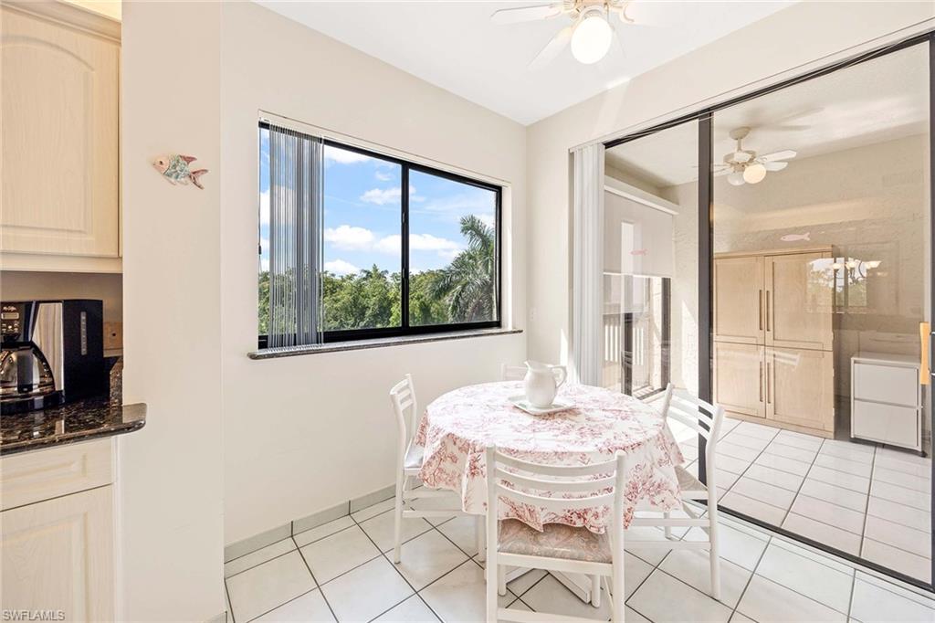 6500 Valen Way, Unit A402 Naples, FL 34108 - Photo 20 of 49 a living room with a large window and furniture