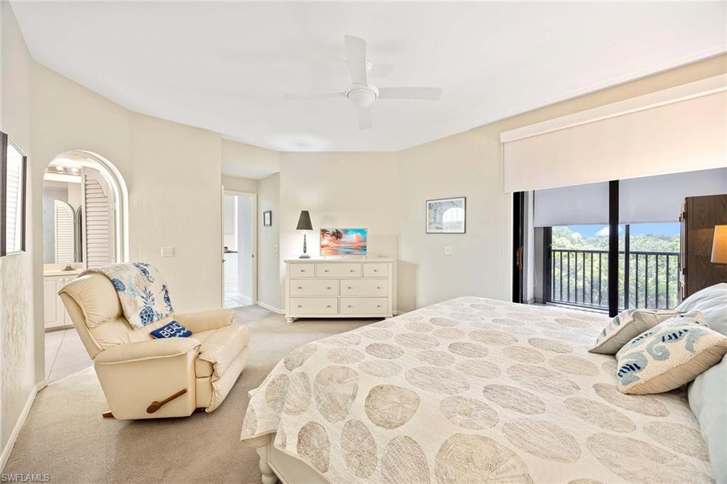 6500 Valen Way, Unit A402 Naples, FL 34108 - Photo 23 of 49 a bedroom with a bed mirror and window