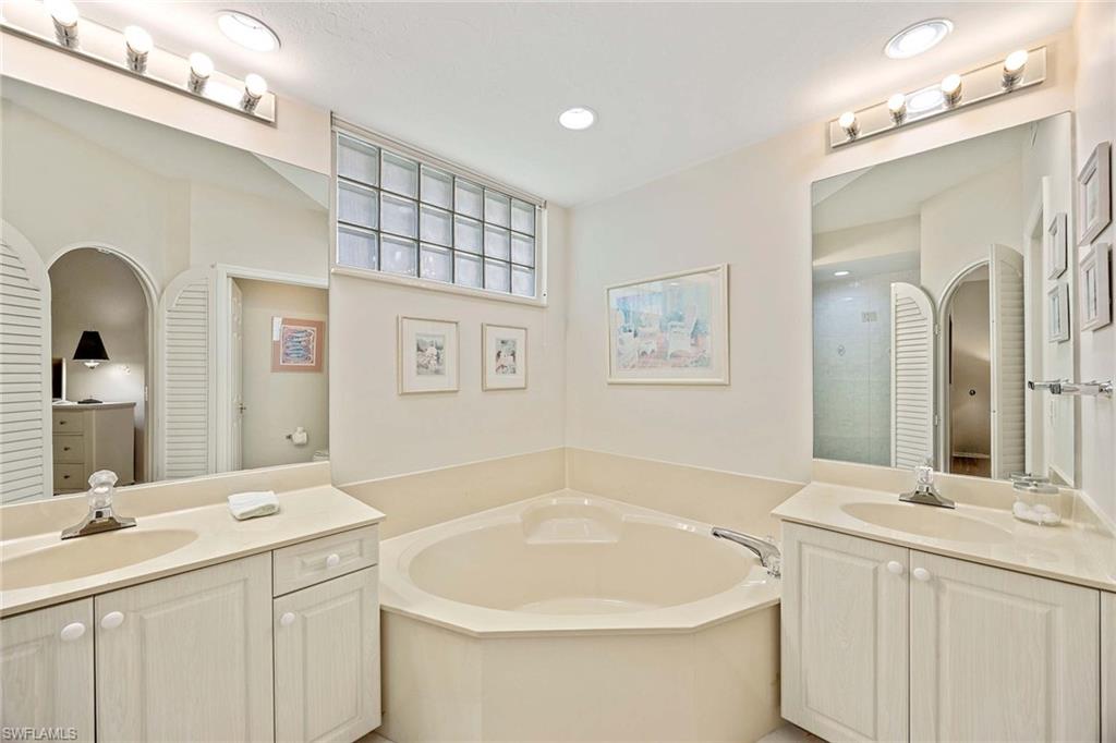 6500 Valen Way, Unit A402 Naples, FL 34108 - Photo 24 of 49 a bathroom with a sink and a mirror