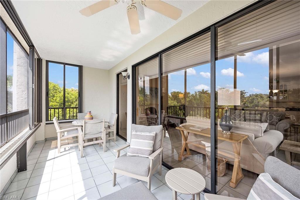 6500 Valen Way, Unit A402 Naples, FL 34108 - Photo 34 of 49 a living room with furniture and a large window