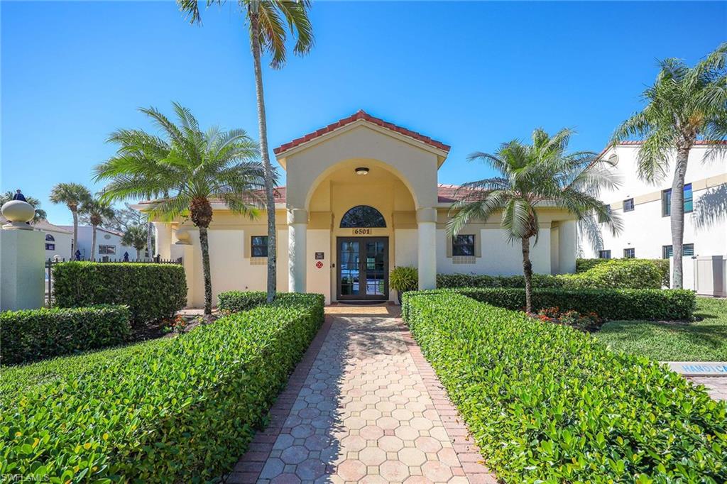 6500 Valen Way, Unit A402 Naples, FL 34108 - Photo 36 of 49 a front view of a house with garden