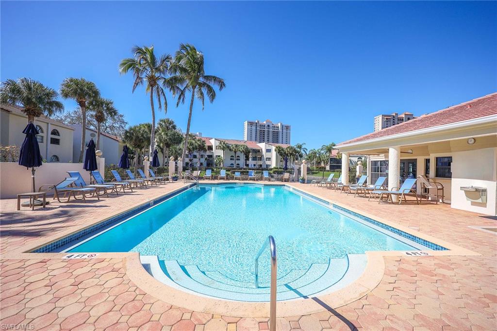 6500 Valen Way, Unit A402 Naples, FL 34108 - Photo 37 of 49 a swimming pool with outdoor seating and yard