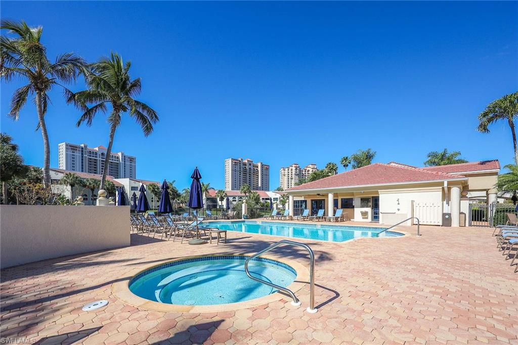 6500 Valen Way, Unit A402 Naples, FL 34108 - Photo 38 of 49 a swimming pool with outdoor seating and yard