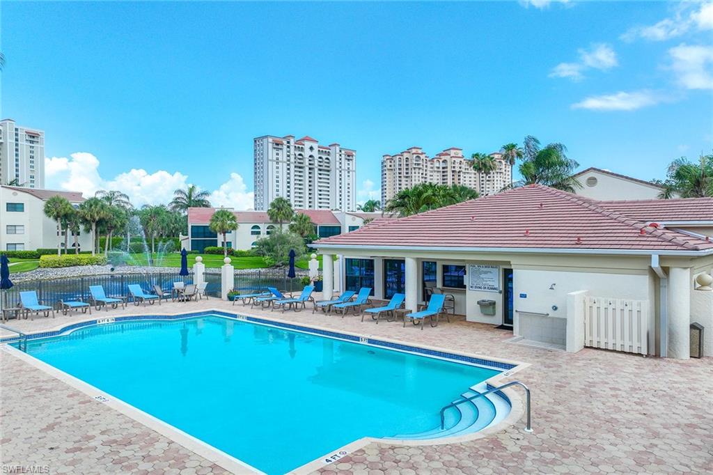 6500 Valen Way, Unit A402 Naples, FL 34108 - Photo 40 of 49 a view of a patio with swimming pool table and chairs