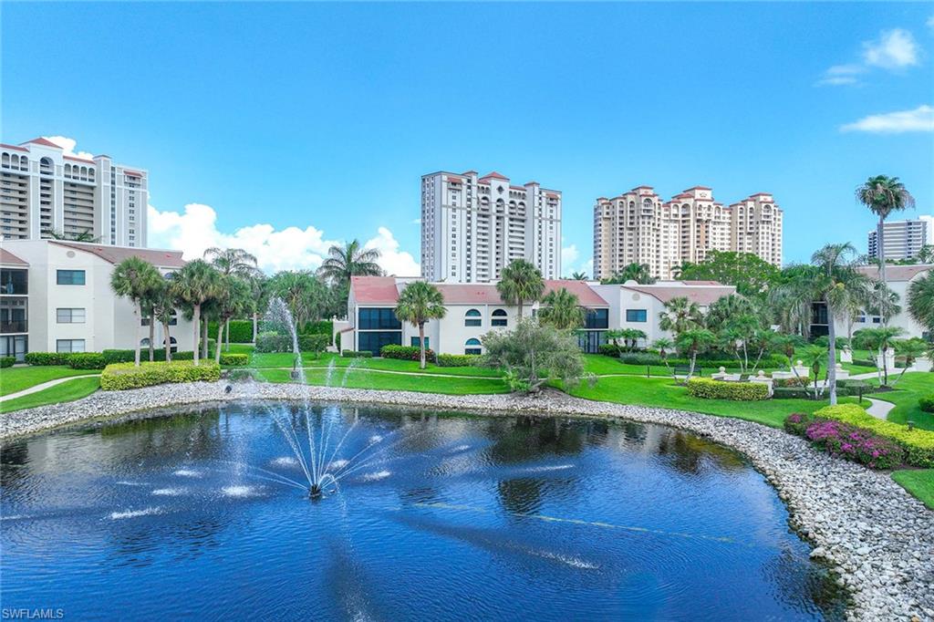 6500 Valen Way, Unit A402 Naples, FL 34108 - Photo 41 of 49 a view of a water with a building in the background