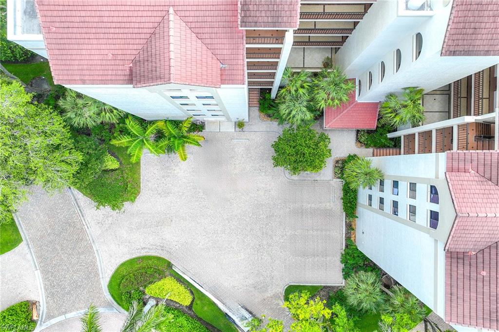 6500 Valen Way, Unit A402 Naples, FL 34108 - Photo 8 of 49 an aerial view of a house with a yard and potted plants
