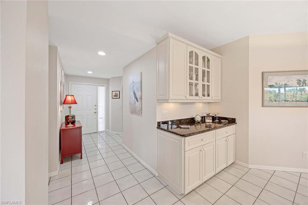 6500 Valen Way, Unit A402 Naples, FL 34108 - Photo 9 of 49 a kitchen with stainless steel appliances granite countertop a stove and a refrigerator