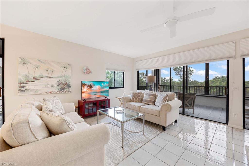 6500 Valen Way, Unit A402 Naples, FL 34108 - Photo 10 of 49 a living room with furniture and a large window