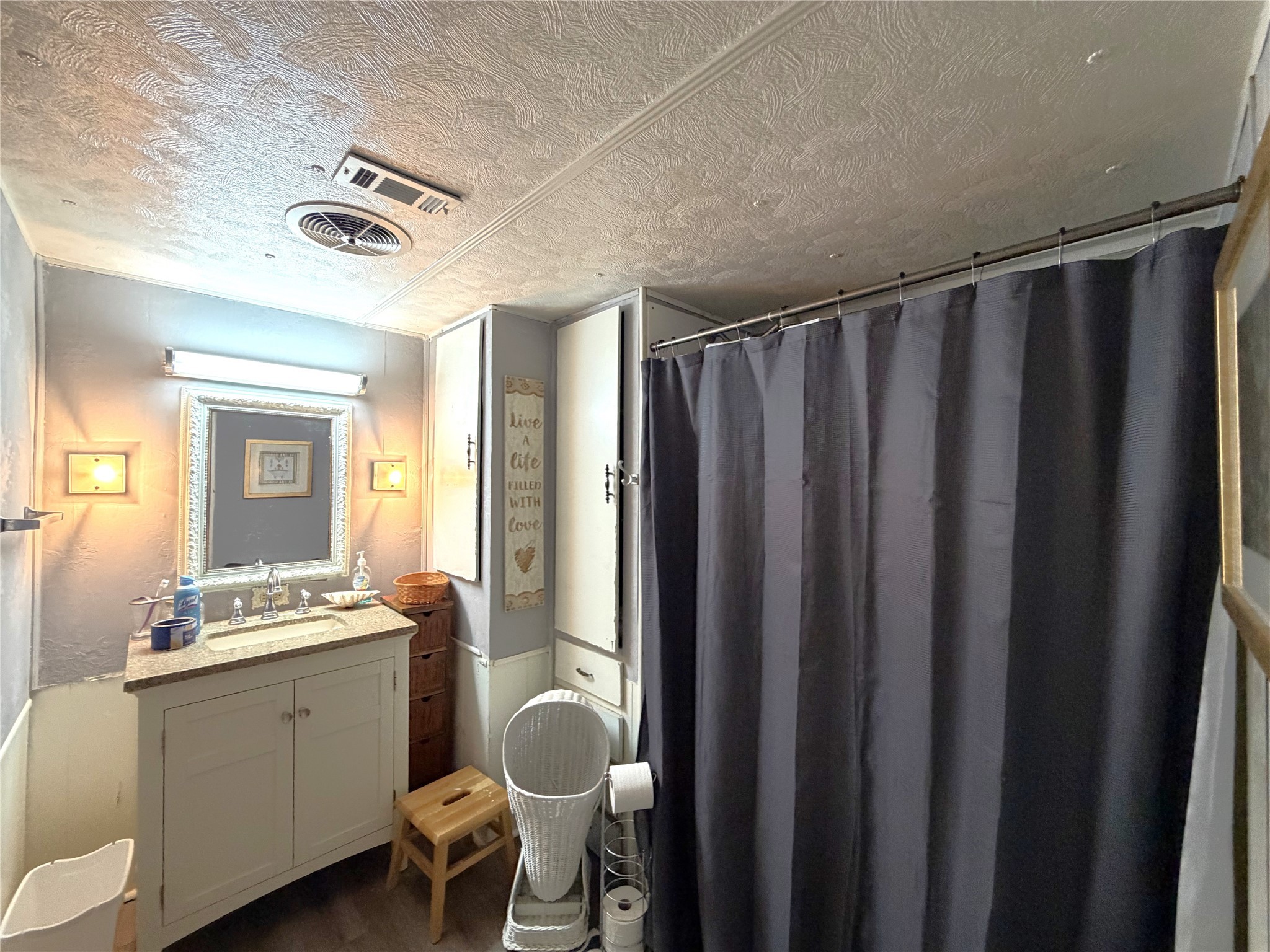 161 East Waltz Lane Trinity, TX 75862 - Photo 25 of 39 a bathroom with a mirror a sink and a shower