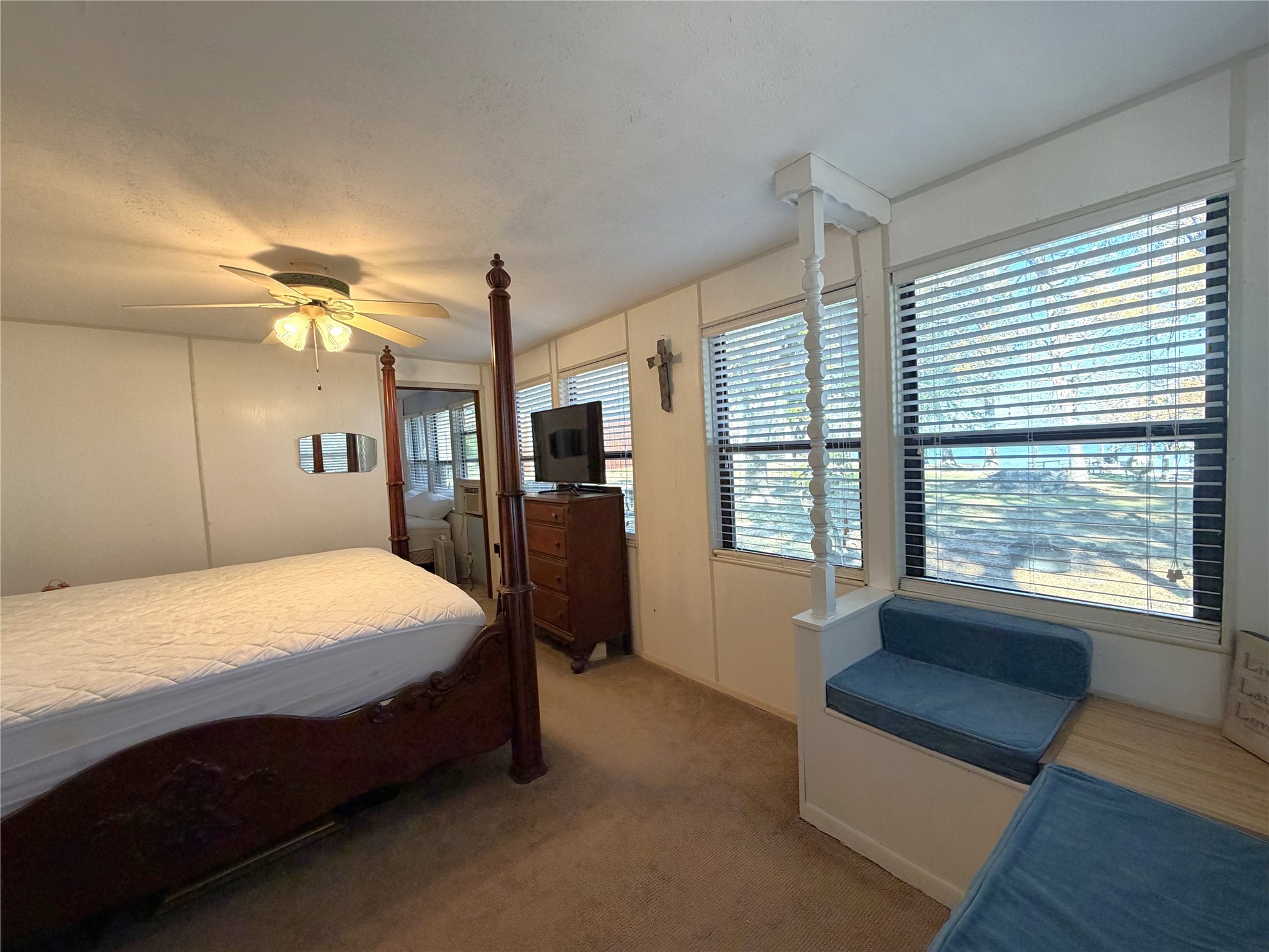 161 East Waltz Lane Trinity, TX 75862 - Photo 28 of 39 a spacious bedroom with a large bed and a dresser next to a window