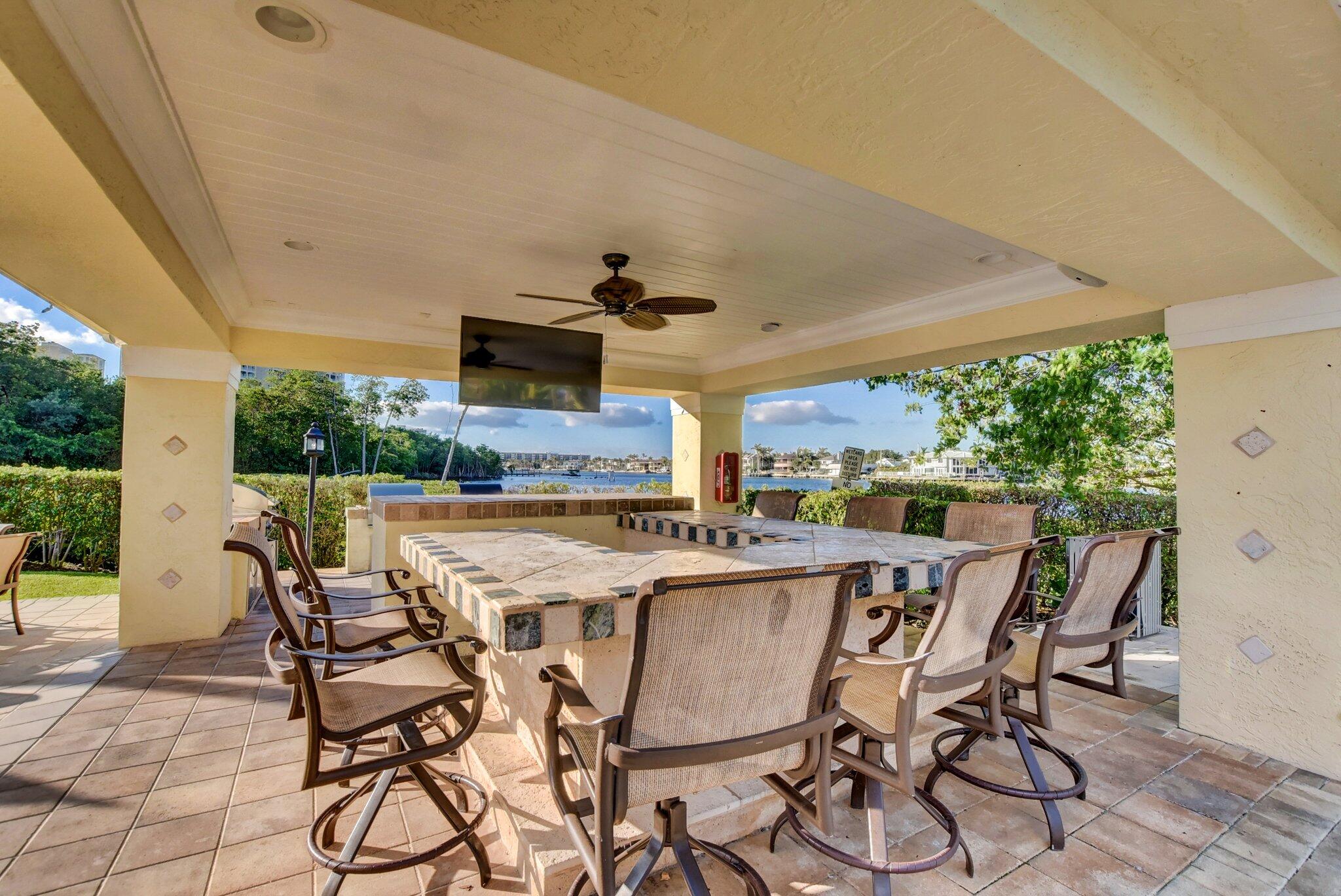 3606 South Ocean Boulevard, Unit 406 Highland Beach, FL 33487 - Photo 17 of 30 a view of a dining table and chairs in the patio