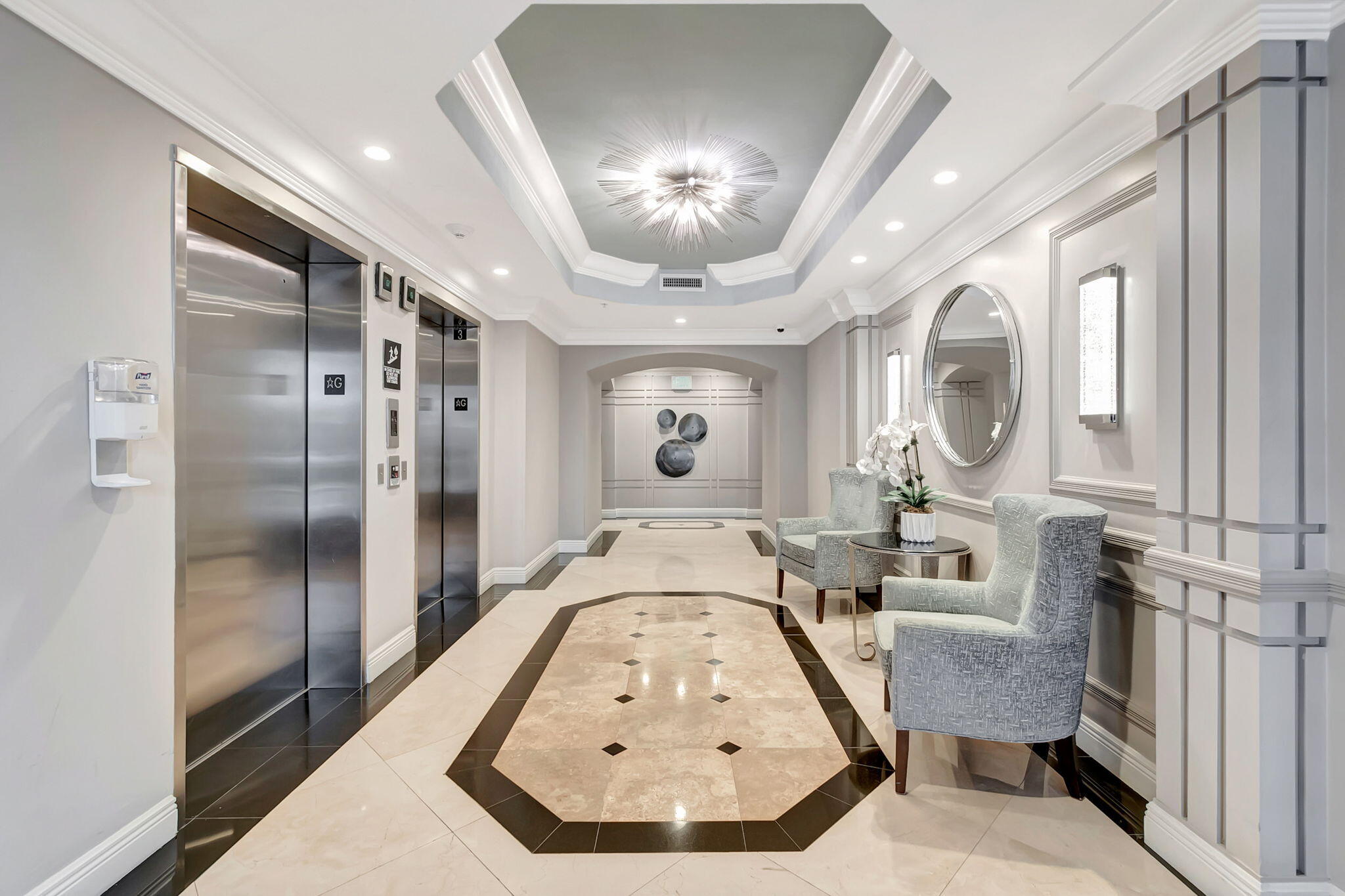 3606 South Ocean Boulevard, Unit 406 Highland Beach, FL 33487 - Photo 19 of 30 a view of a hallway with couches and chandelier