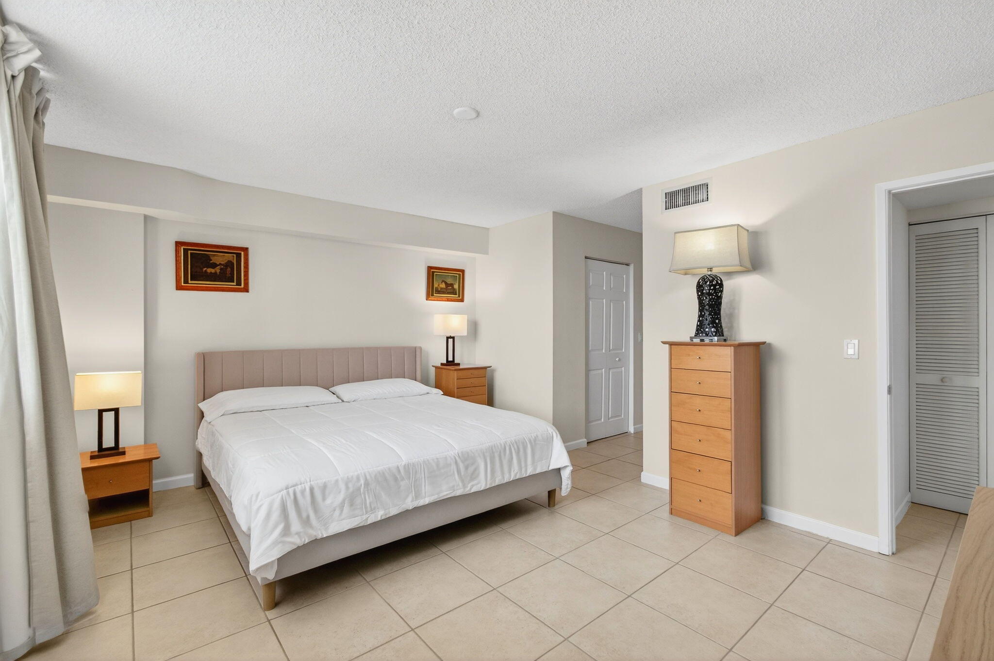 3606 South Ocean Boulevard, Unit 406 Highland Beach, FL 33487 - Photo 24 of 30 a bedroom with a bed and a lamp