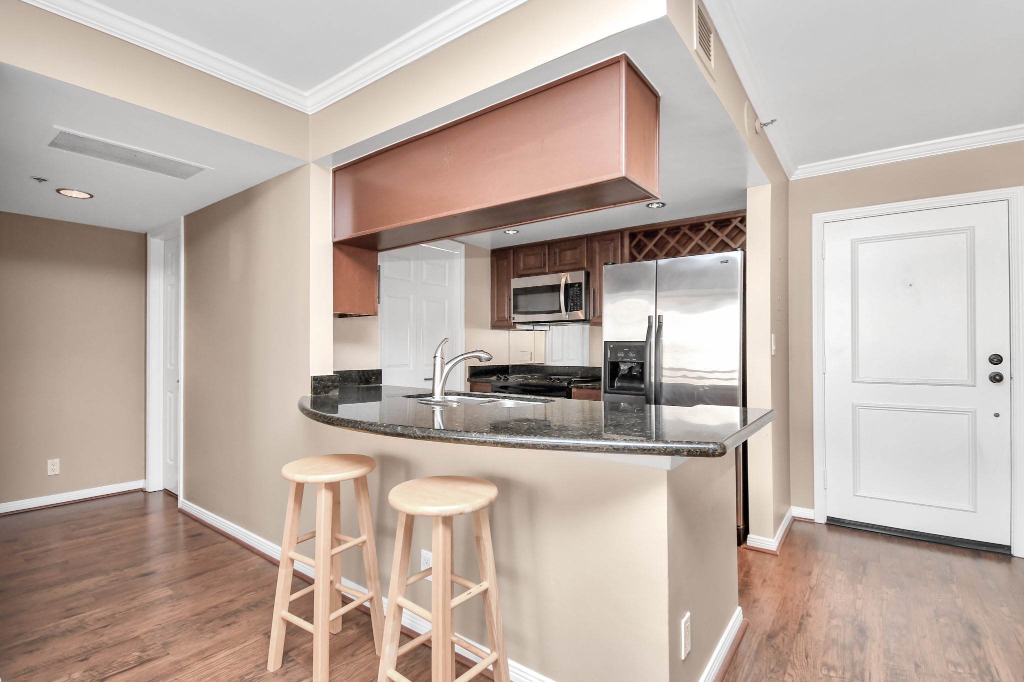 3525 Sage Road, Unit 1314 Houston, TX 77056 - Photo 23 of 40 a kitchen with stainless steel appliances granite countertop a sink and a refrigerator