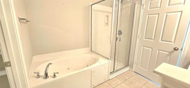 a bathroom with a tub and shower
