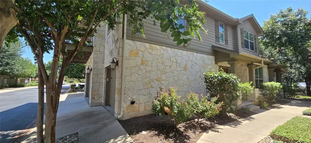 a view of a pathway of a house with a tree